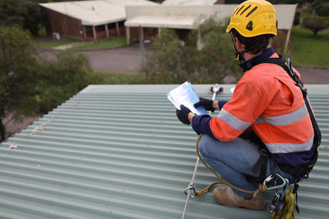 Worker conducing an inspection on a roof