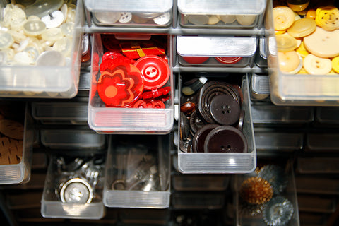 hardware container with the drawers open showing the buttons that are stored inside