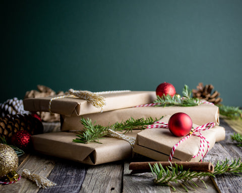 books wrapped in brown paper with candy canes and red ornaments