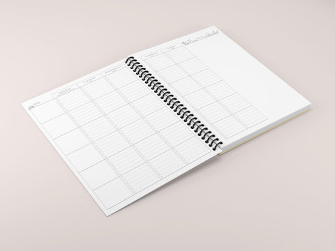 a spiral planner laid open on a pink background