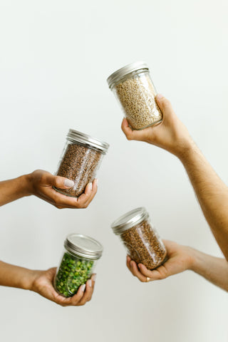 hands holding seed jars
