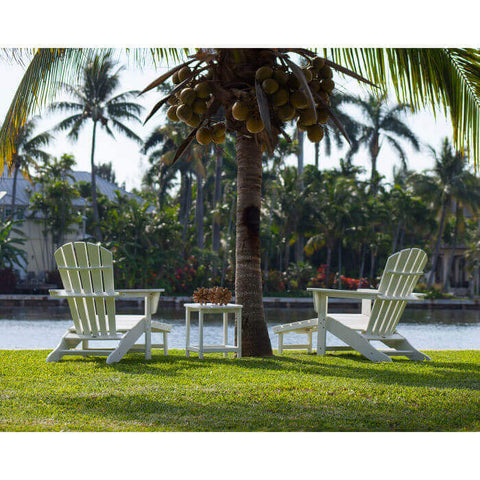 Relax beneath the shade of the palm tree in the Adirondack chairs with ottoman and side table