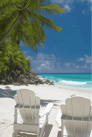 Two white Adirondack chairs under the palm trees on tropical beach