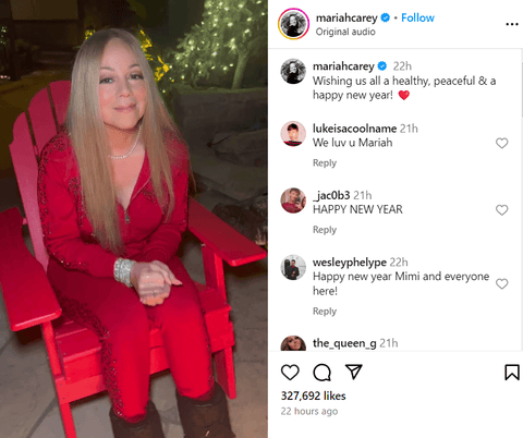 musician Mariah Carey, dressed in a sequined red tracksuit, sitting in a matching Adirondack chair next to a fire pit.png