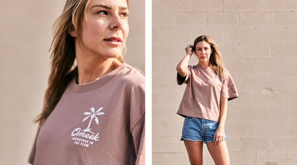 Woman wearing Omeek brand shirt with palm tree graphic