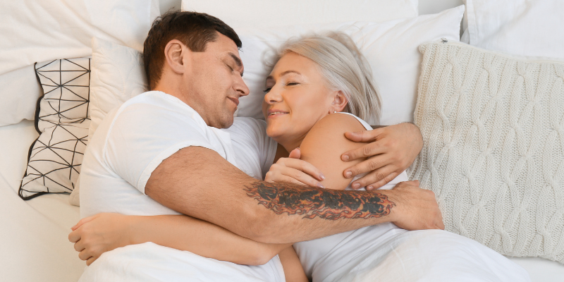 Mature couple lying in bed together