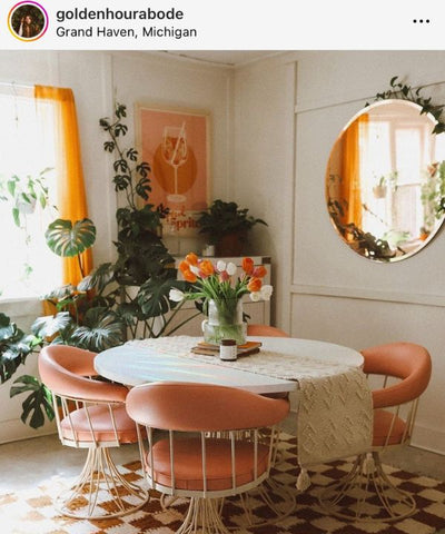 @goldenhourabode uses variously matured Monstera deliciosa plants to compliment a 1940’s inspired round white dining table with dusty rose velvet chairs.