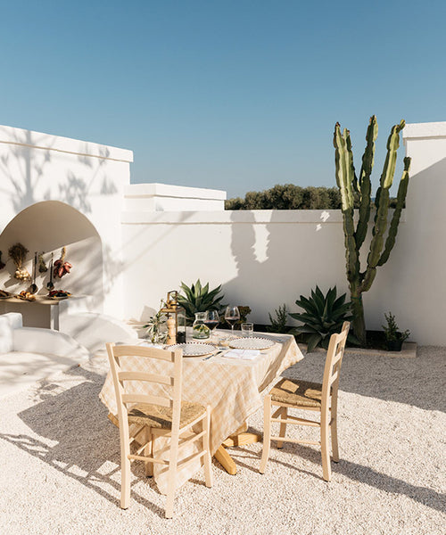 Minimalist Californian pebbled outdoor dining area showcasing a feature Euphorbia ammak.