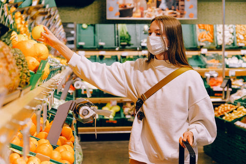 Woman in supermarket shopping for fruits and vegetables