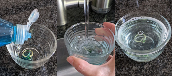 Soaking a ring in hot soapy water to clean the ring