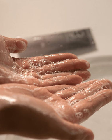 hands with soapy detergent