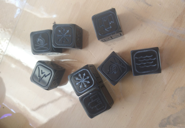 a collection of shiny black six-sided dice