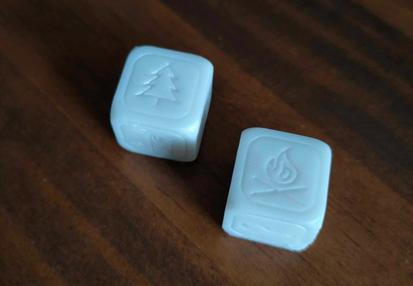 two 3d printed white dice sitting on a table