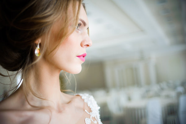 confident bride wearing jewelry for a wedding day