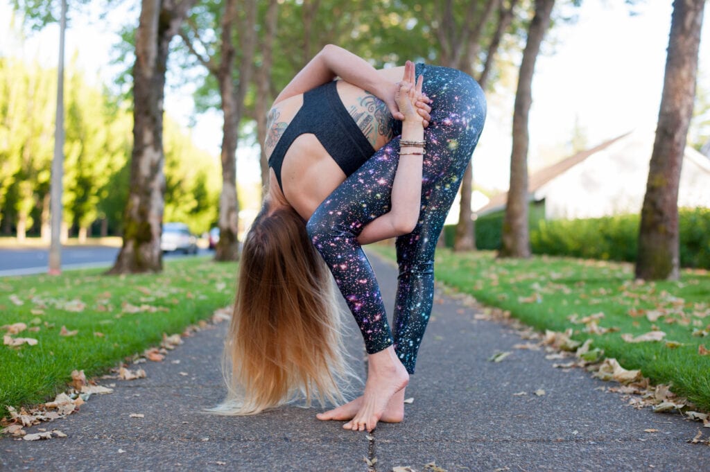 forward fold yoga pose variation with a bind