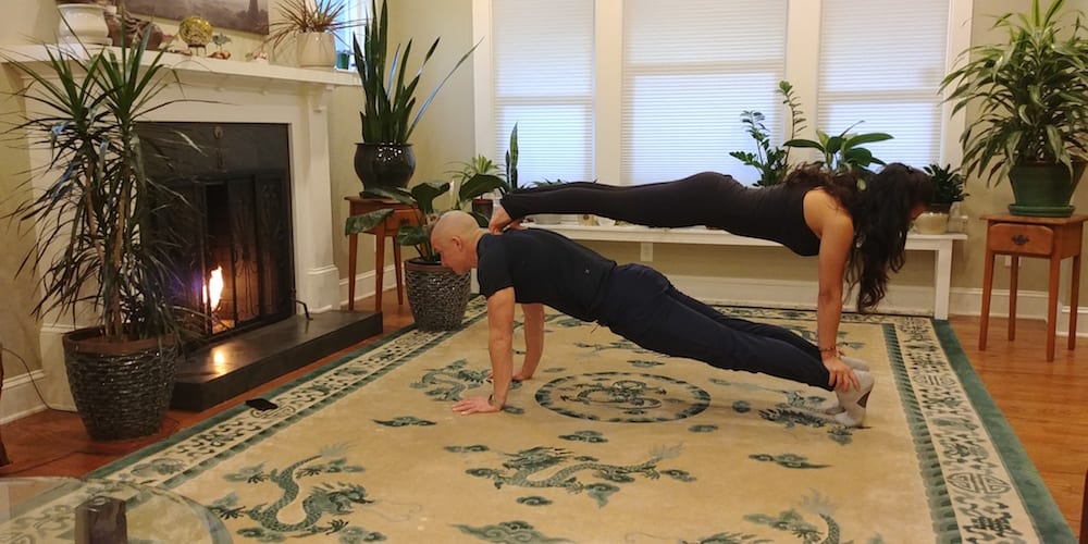 Premium Photo | Young couple doing acro yoga in pair at studio