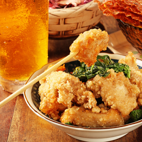 Taiwanese fried chicken with fresh basil and an ice cold beer