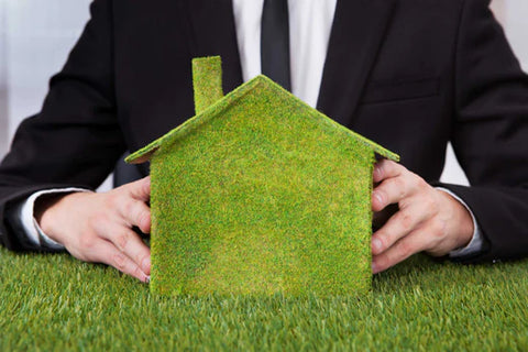 Man with small grass house