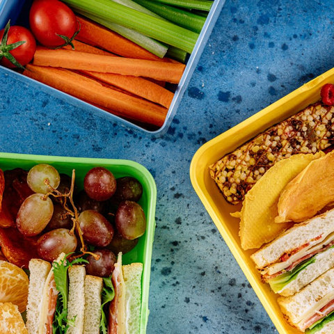 kids lunch box with veggies, snacks, and sandwiches 
