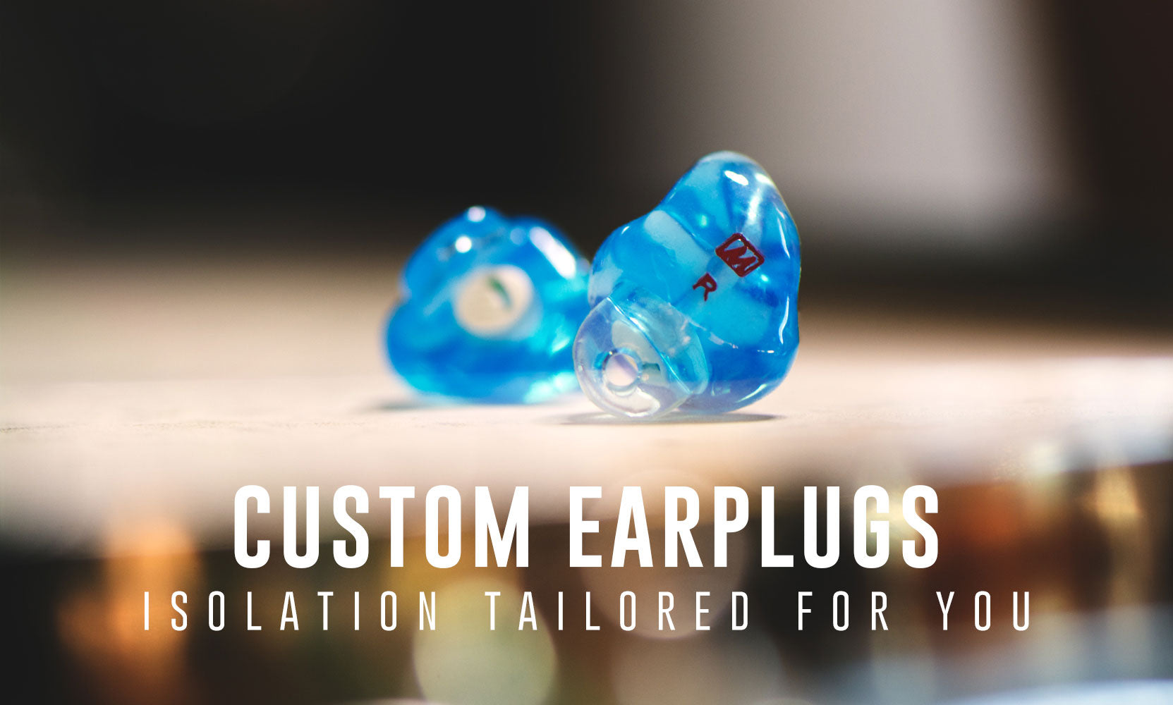 Blue custom ear plugs with a caption that reads Isolation Tailored for You