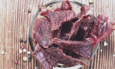 Beef jerky stored in a glass dish