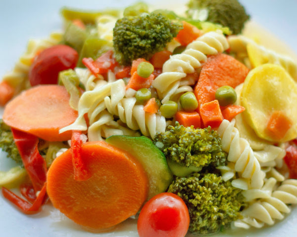 Pasta broccoli salad close up on white plate