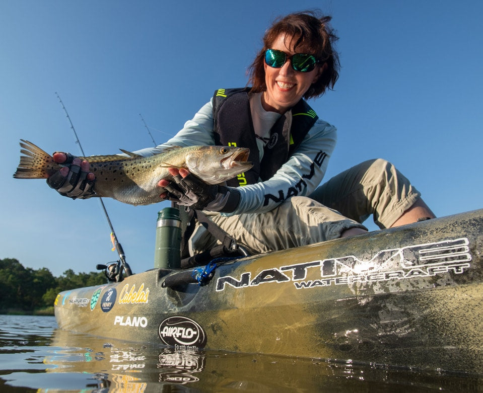 Angler proudly holding up fish caught in a Native Watercraft Slayer Propel 10