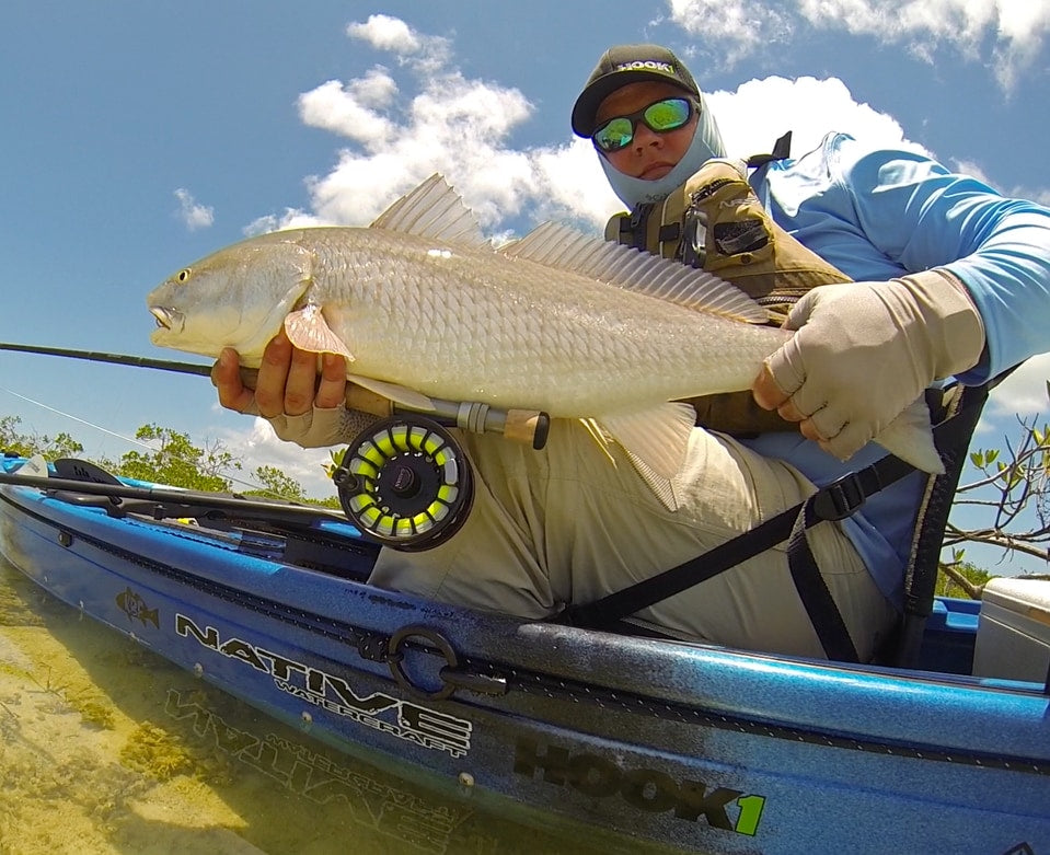 Angler holding fish caught in a Native Watercraft Ultimate FX 15