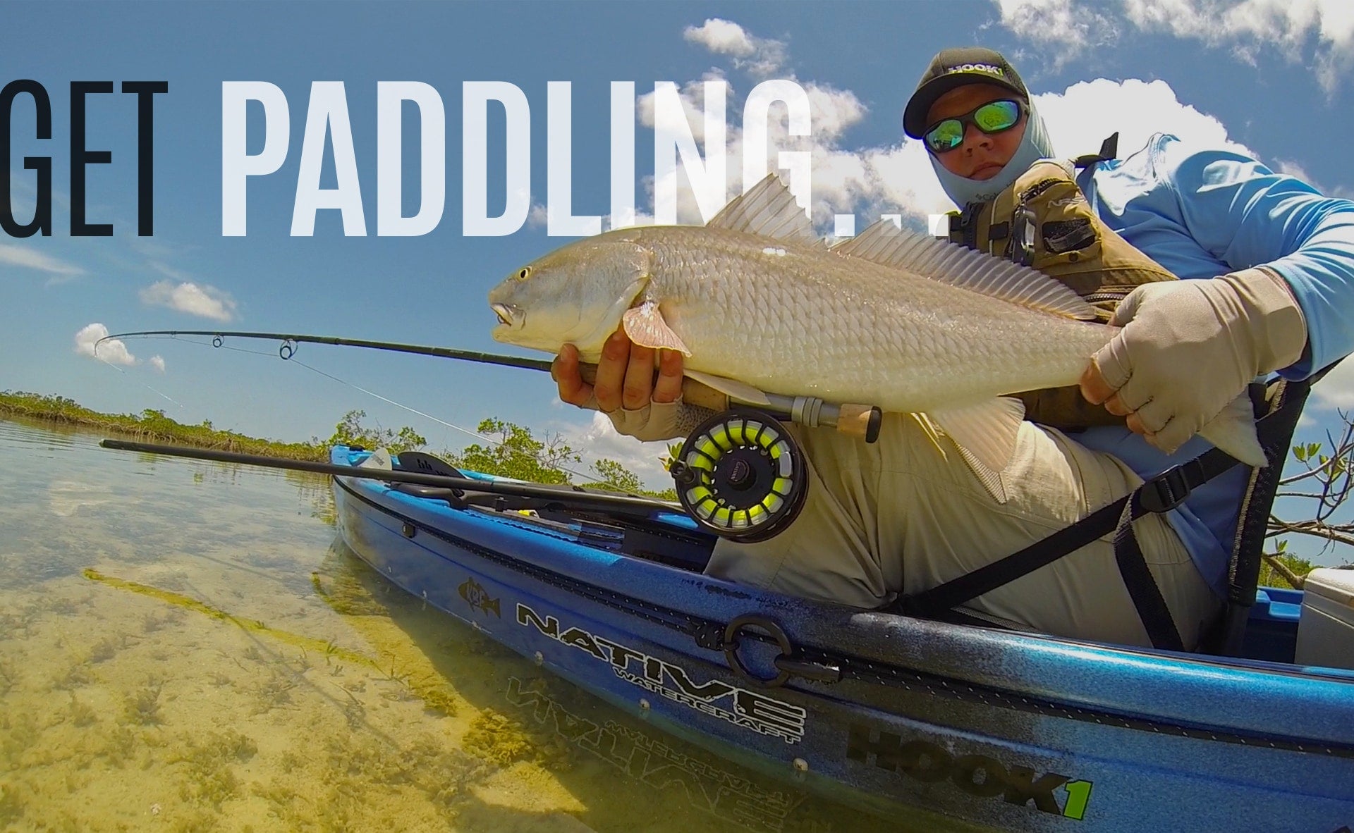 Angler holding up fish in their Native Watercraft Hook 1 kayak