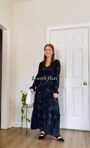 Digital creator for sustainable brands Nicol, is wearing the black deema sustainable maxi-dress with black fancy flats and a grey shoulder purse