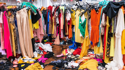 An over abundance of clothing, from floor to ceiling, wall to wall, nothing else can be seen