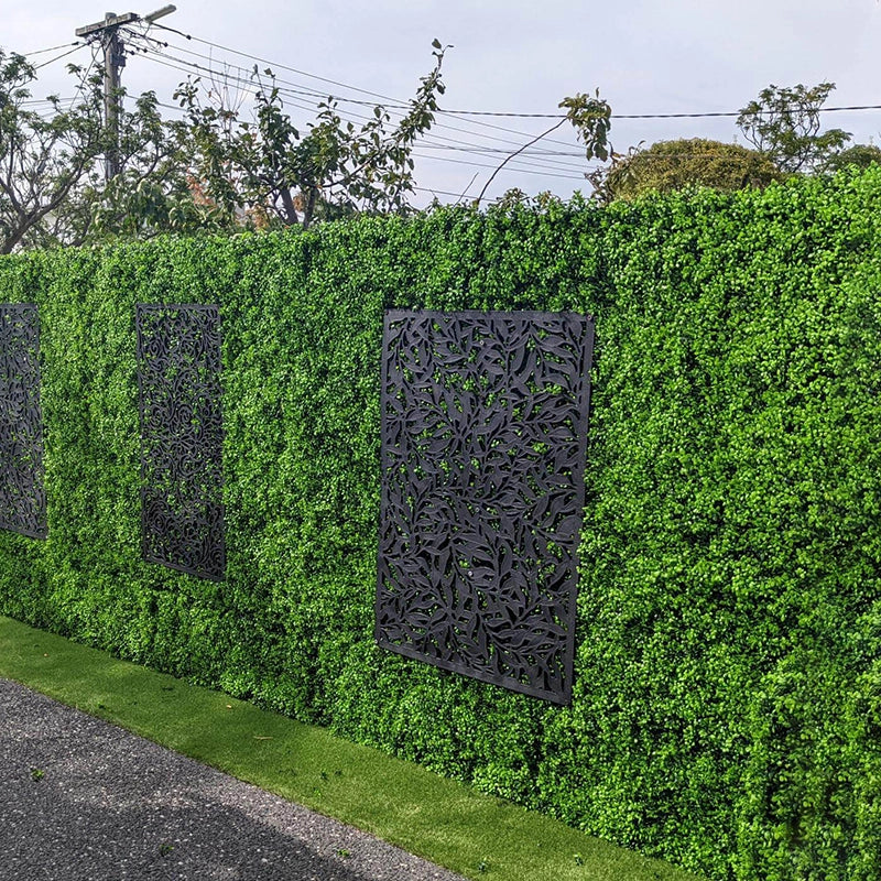Bright Boxwood Hedge Panels Along a Fence