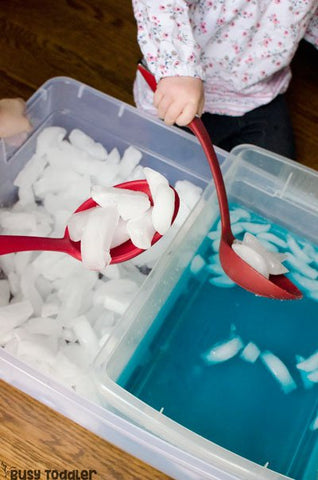 scoop and transfer ice cubes in a water sensory play