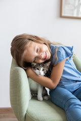 Girl hugging cat