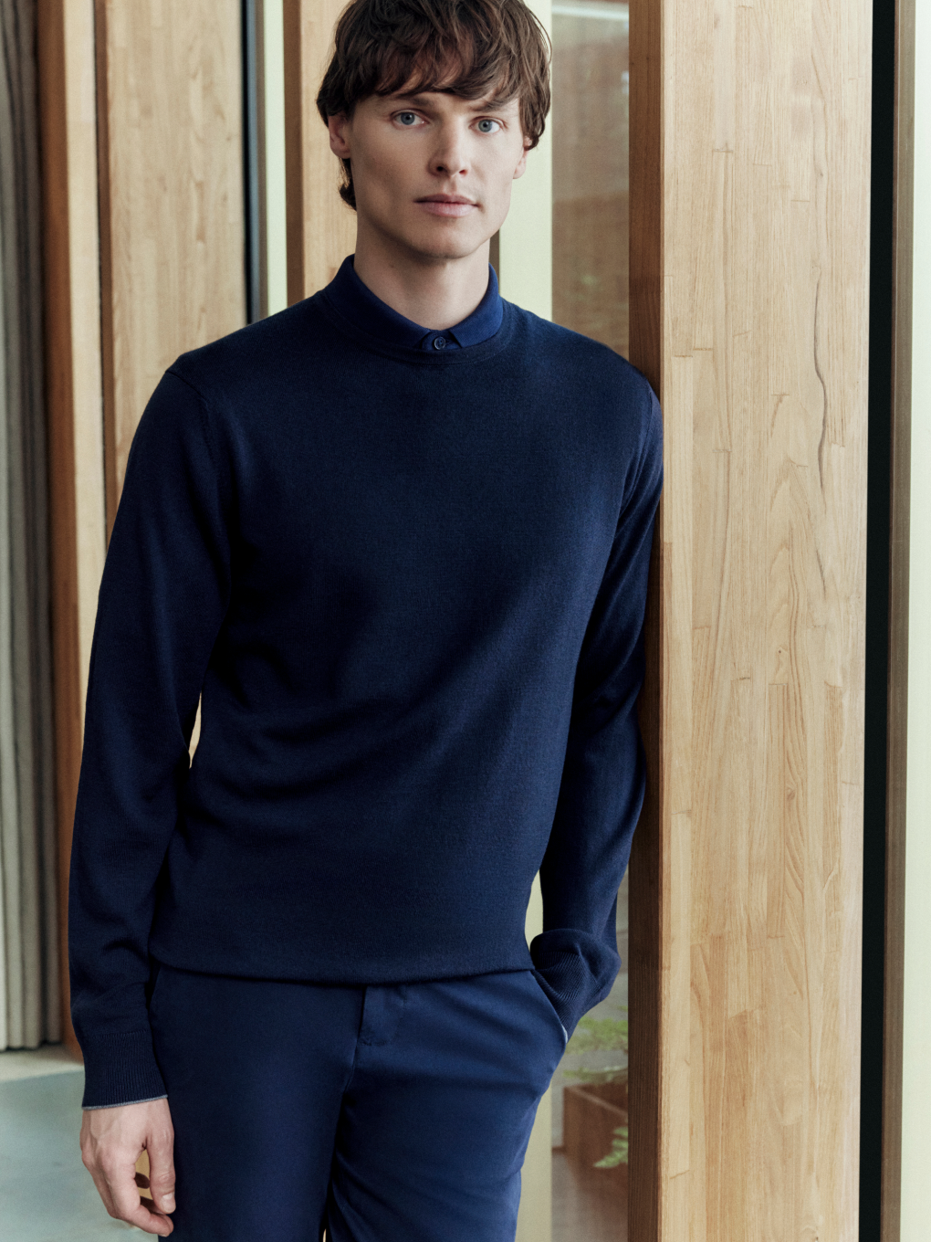 A man wearing a Merino Crew Neck Jumper in Navy