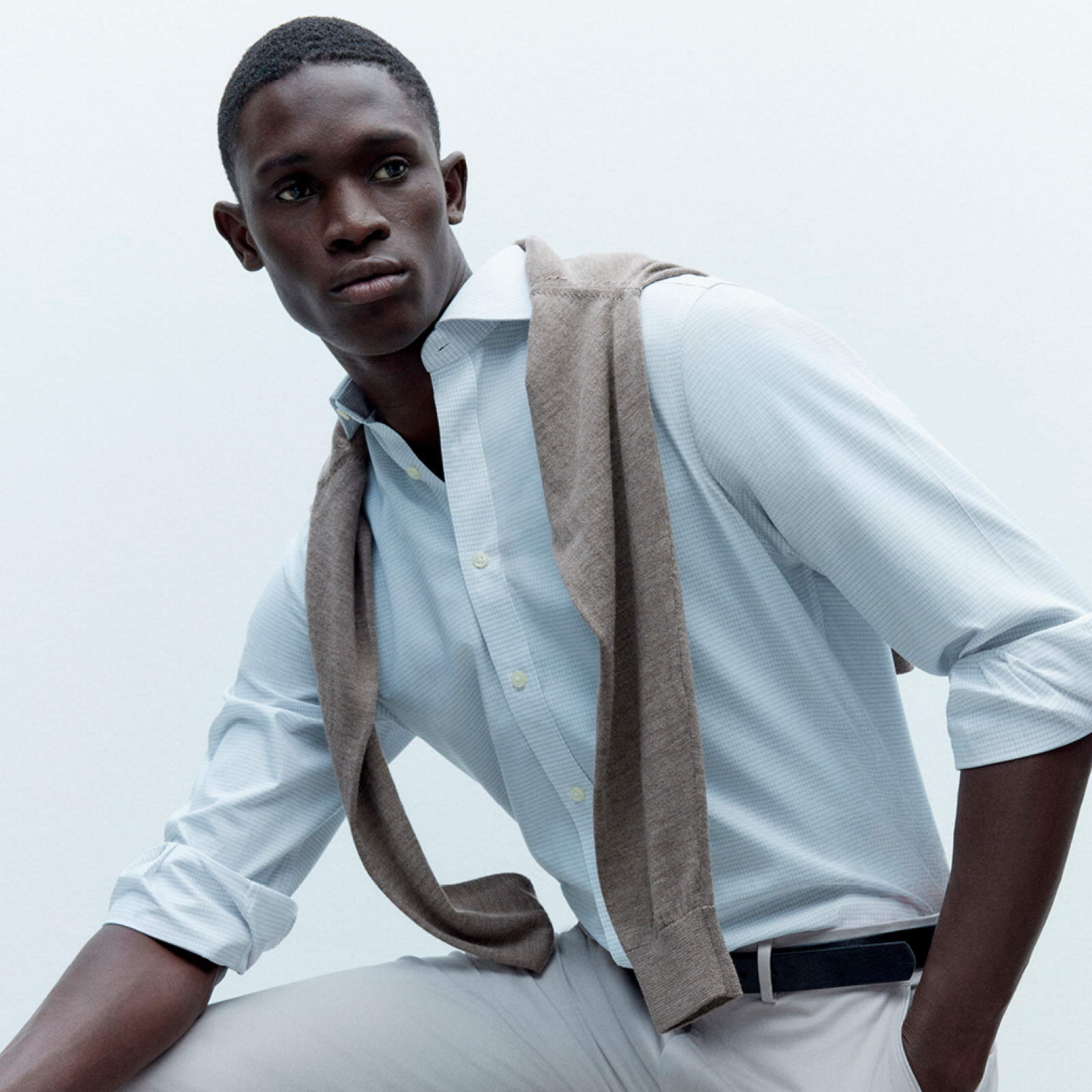 A man wearing light blue shirt paired with a light grey trouser