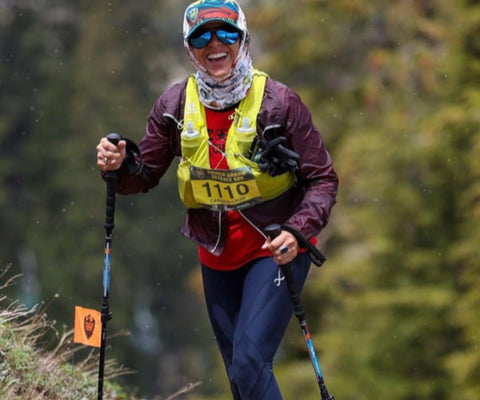 female athlete doing a winter mountain hike wearing endurance generator insulator tights