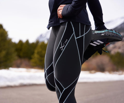 female athlete stretching in endurance generator insulator tights