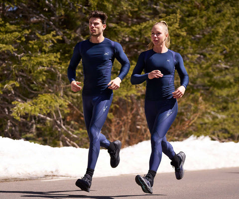 male and female athlete running on road in endurance generator insulator tights in navy