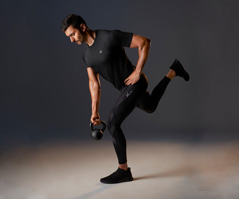 male athlete doing a 1 leg forward squat with a kettle bell in endurance generator tights