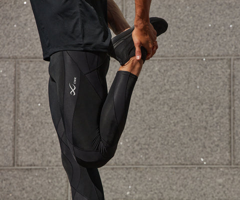 male athlete stretching to train for marathon wearing endurance generator tights