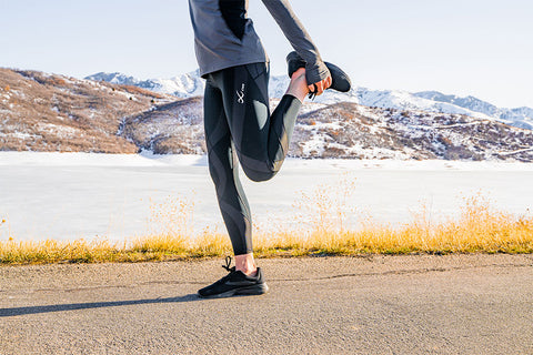 male athlete stretching before hike wearing endurance generator tights