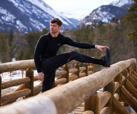 male athlete stretching in endurance generator insulator tights