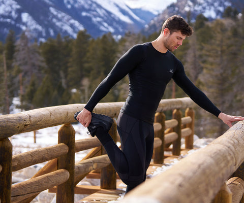 male athlete stretching in endurance generator tights before a hike