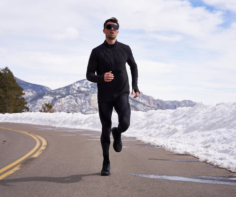 male athlete running on road wearing endurance generator insulator tights