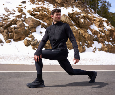 male athlete stretching after a day in skiing in endurance generator insulator tights