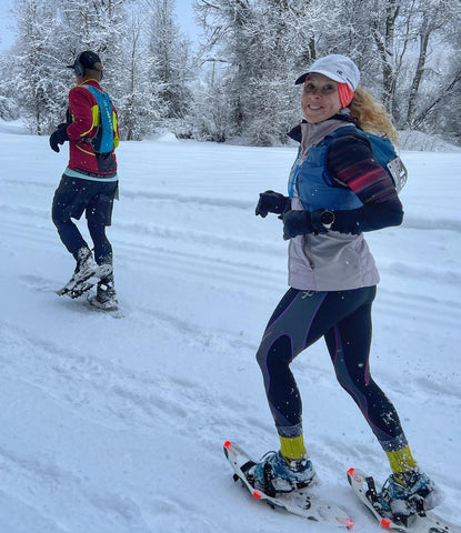 female athlete cross-country running in the snow in cw-x tights