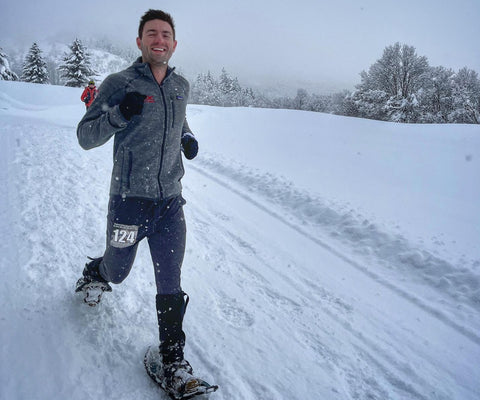 male athlete cross-country running in cw-x tights in the snow