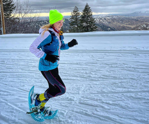 female cross-country running in the snow wearing cw-x tights