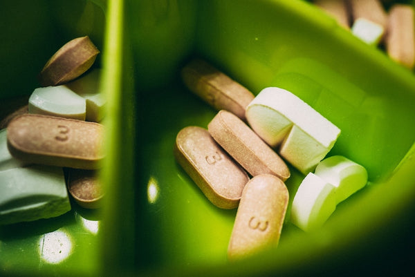 various supplements in a green container